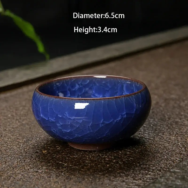 A deep cobalt blue ice cracking ceramic tea bowl with crackled glaze and brown rim for decorbites ice cracking set