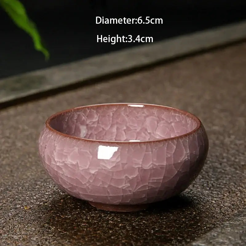A delicate pink ice cracking ceramic tea bowl with crackled glaze and subtle brown rim for kitchen decorbites decor