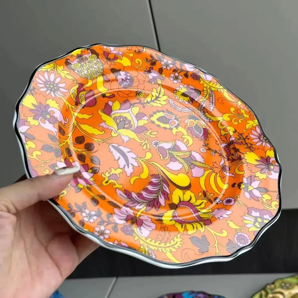 A vibrant orange ceramic saucer from decorbites jungle flower bone dining plates set with intricate floral pattern