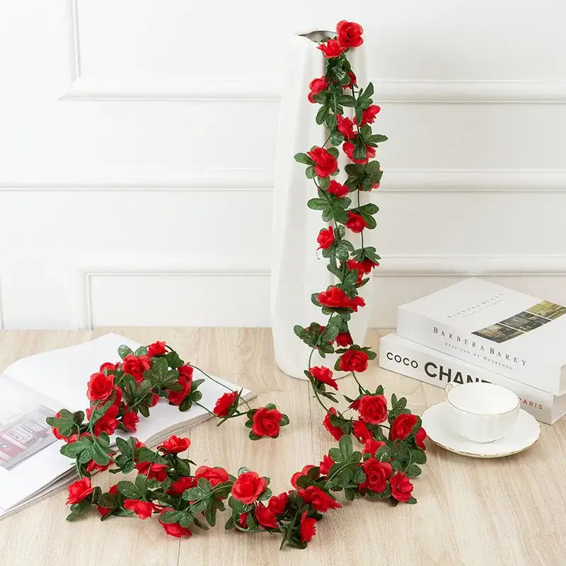 A vibrant red rose flowers vine garland with lush green leaves designed for living room decor and artificial use