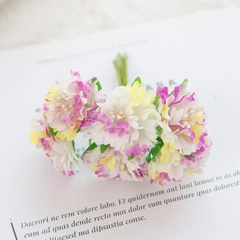 A delicate bouquet of decorbites carnation stamen silk flowers in soft pink white and yellow for living room decor