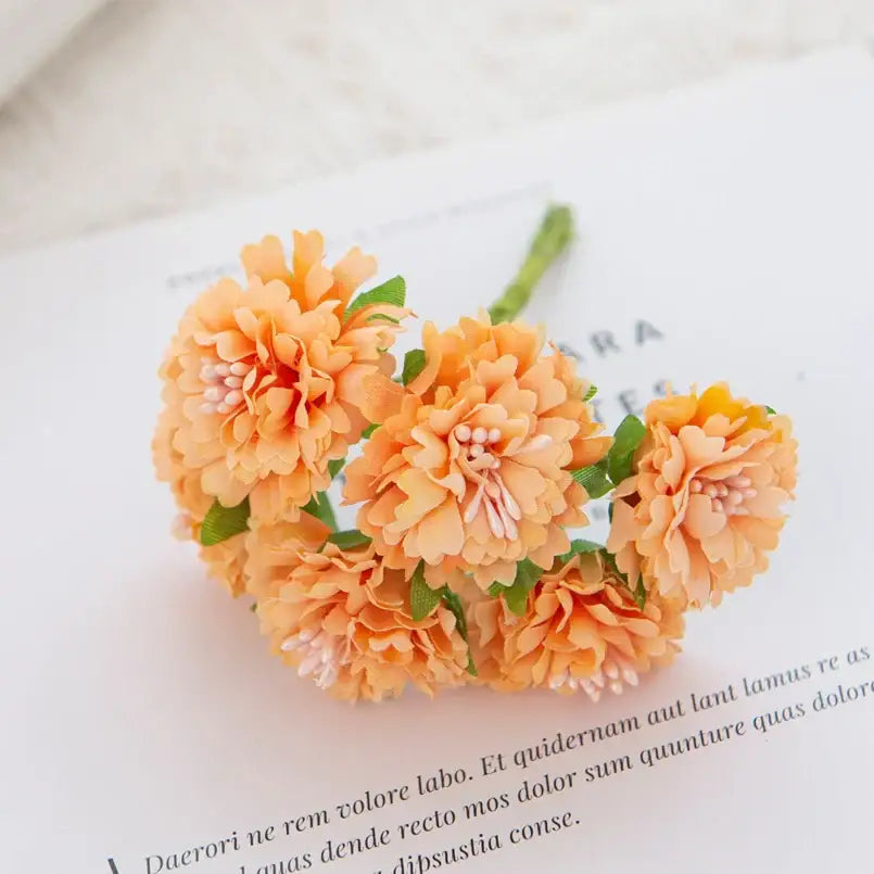 A cluster of peach-colored silk flowers with carnation stamen and green leaves for decorbites carnation stamen decor