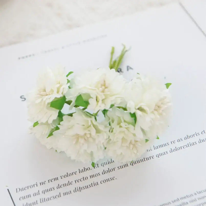 A delicate cluster of white silk flowers featuring decorbites carnation stamen for vibrant living room decor