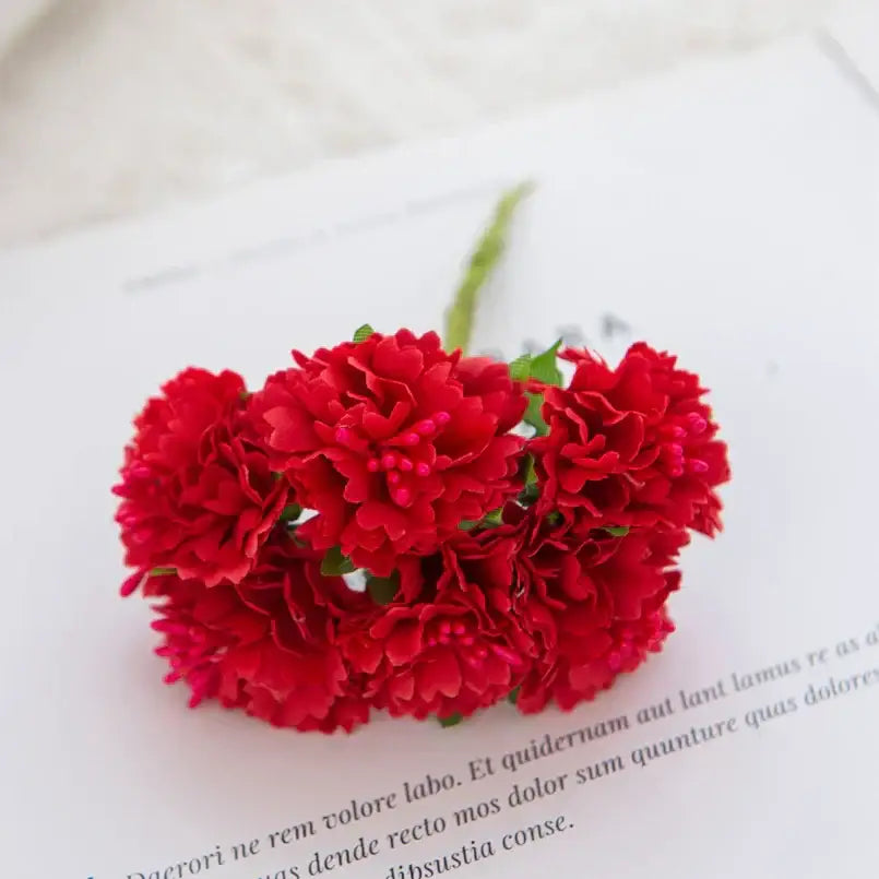 A cluster of vibrant red silk flowers carnation stamen by decorbites for living room decor
