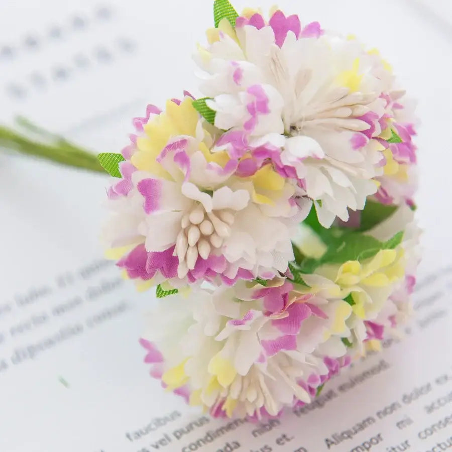A delicate cluster of multicolor decorbites carnation stamen silk flowers in soft white pink and yellow for living room decor