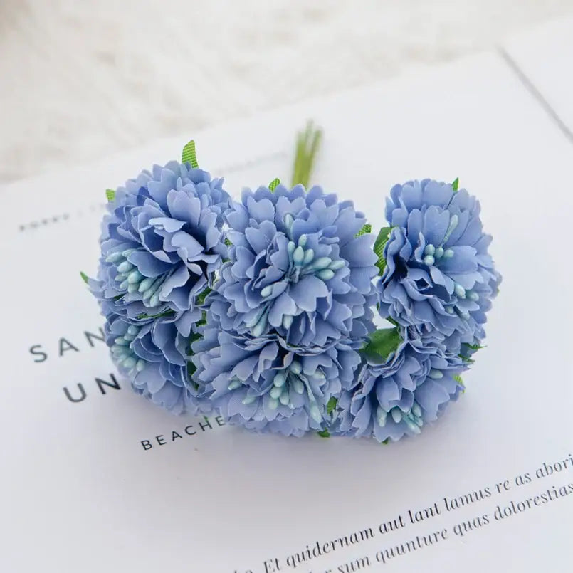 A delicate cluster of light blue silk flowers with carnation stamen decorbites for vibrant living room decor