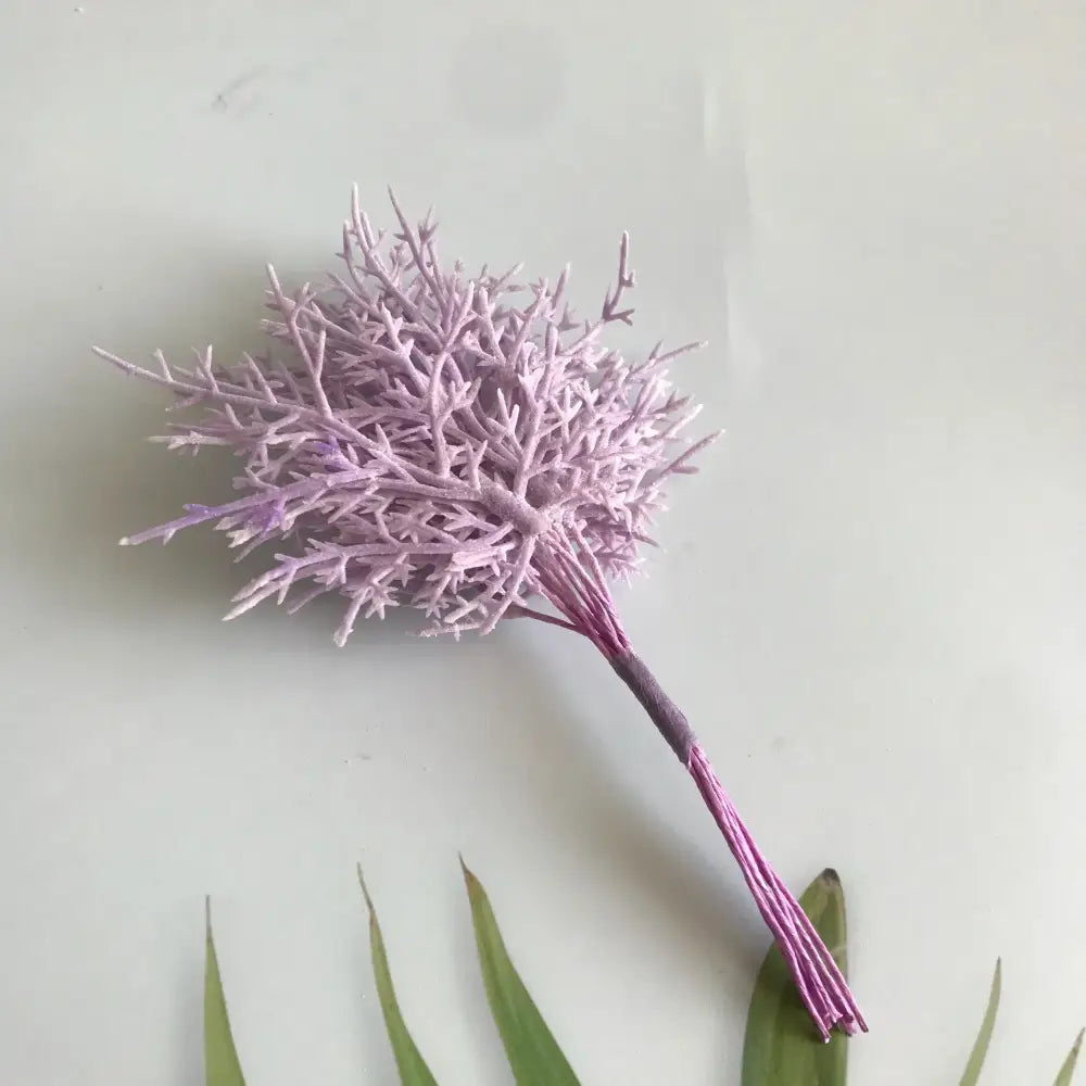 A delicate lavender artificial dried flower bouquet with textured branches in a white vase for living room decor