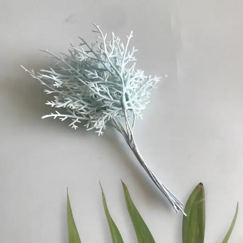A delicate light blue artificial branch with textured feathery design and silver stems in vibrant dried flower bouquets
