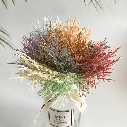 A vibrant multicolored dried flower bouquet in a white ceramic vase with decorative ribbon for living room decor