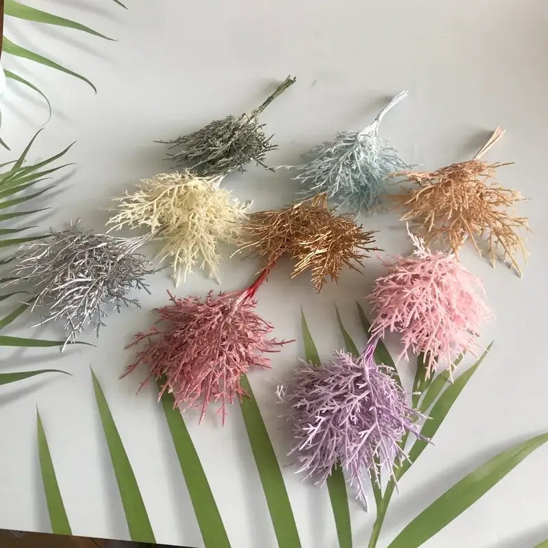 A collection of vibrant multicolored dried flower bouquets in a white vase crafted from synthetic fiber for living room decor