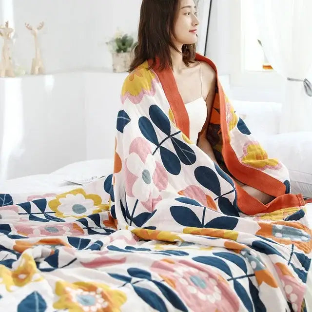 Soft oversized nordic throw blanket with vibrant pink yellow and navy floral pattern on white background for bedrooms