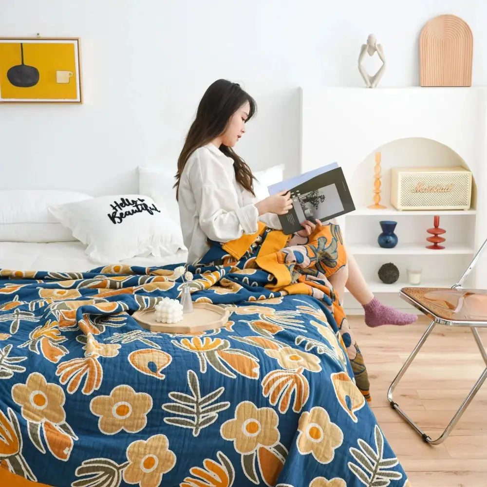Blue throw blanket with vibrant orange and beige floral pattern made of soft cotton for nordic throw bedroom decor