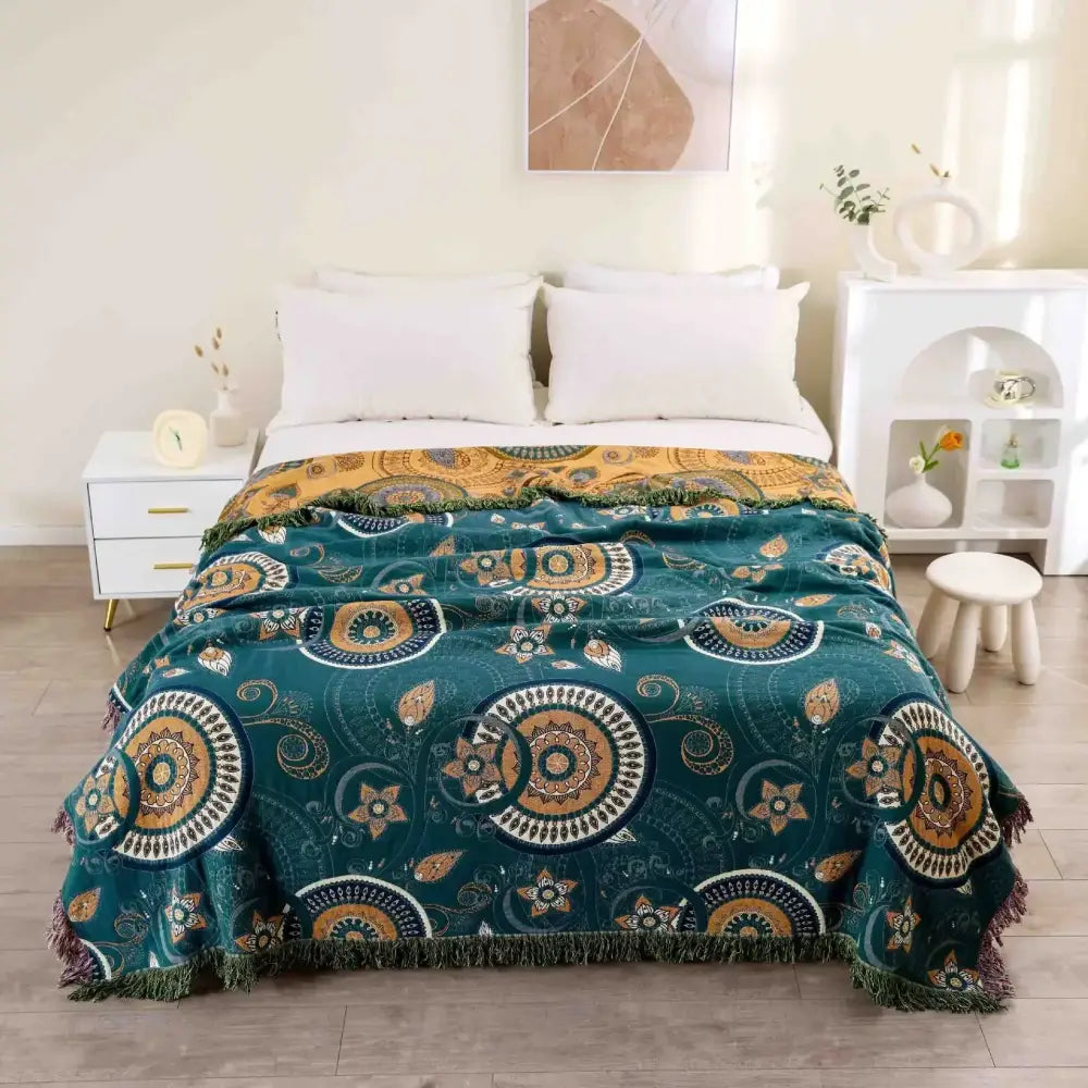 Teal and gold patterned throw blanket with fringe edges complementing a vibrant orange and gold nordic throw blanket design