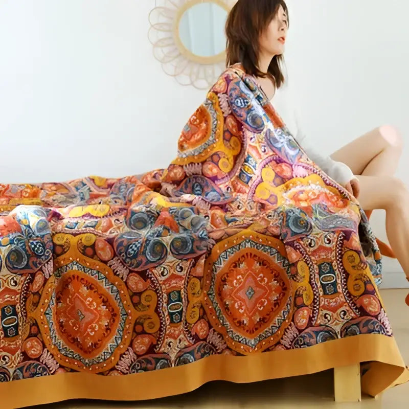 A vibrant orange and gold geometric nordic throw blanket with intricate patterns for bedroom bedspread use