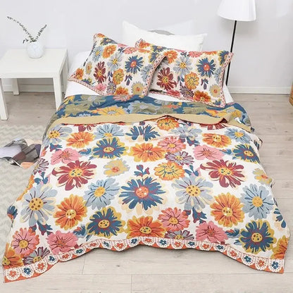 Vibrant nordic throw blanket featuring orange gold geometric and colorful daisy floral patterns with lace trim on cream background
