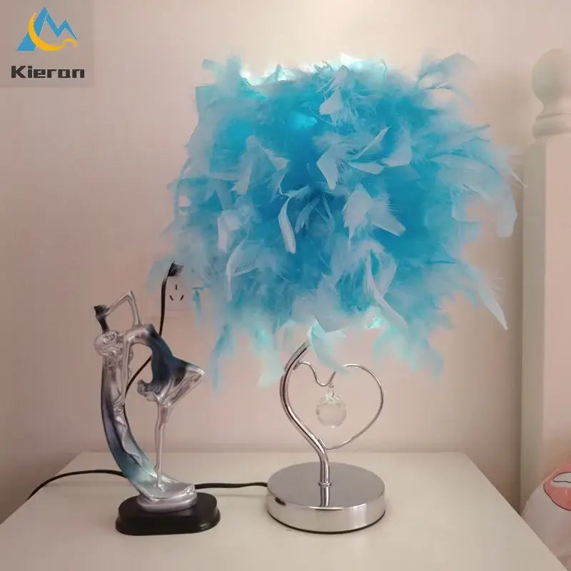 Blue feathered lamp with a heart-shaped metallic base and crystal accent decorbites crystal feather led table lamp