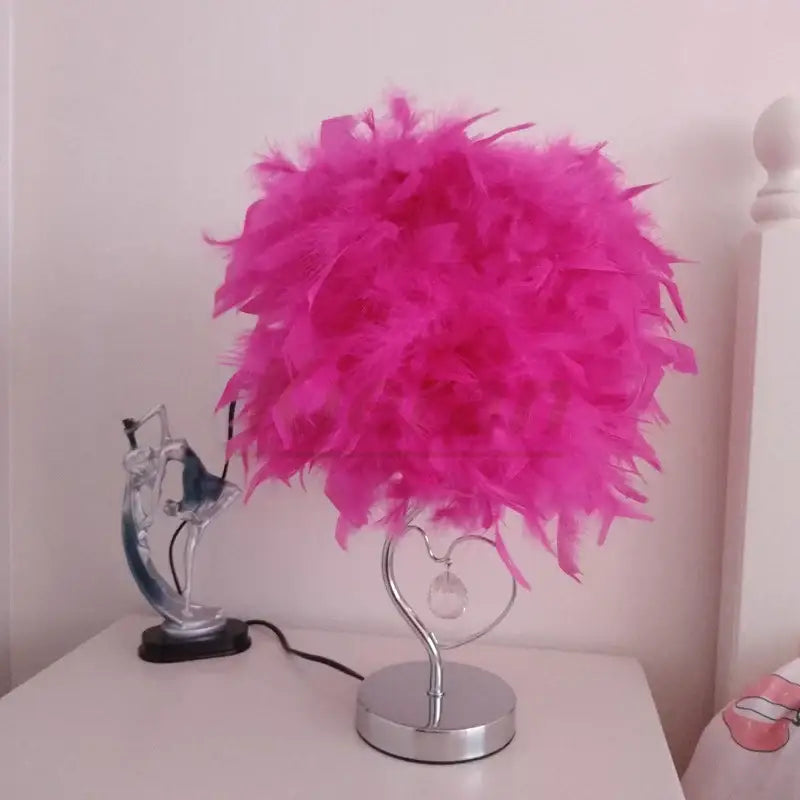 A vibrant pink crystal feather led table lamp with heart-shaped chrome base and crystal accent for bedroom decorbites crystal feather