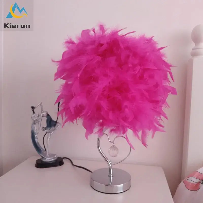 A vibrant pink crystal feather led table lamp with heart-shaped chrome base and crystal accent for bedroom decorbites crystal feather