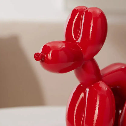 Vibrant red dog balloon poop resin sculpture with glossy finish and smooth contours for living room decorbites decor