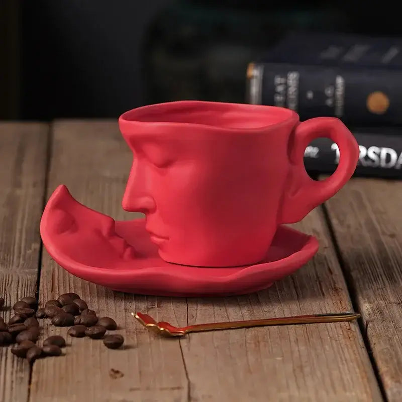 Vibrant red frosted ceramic face mug set by decorbites featuring sculpted design on coffee cup and matching saucer