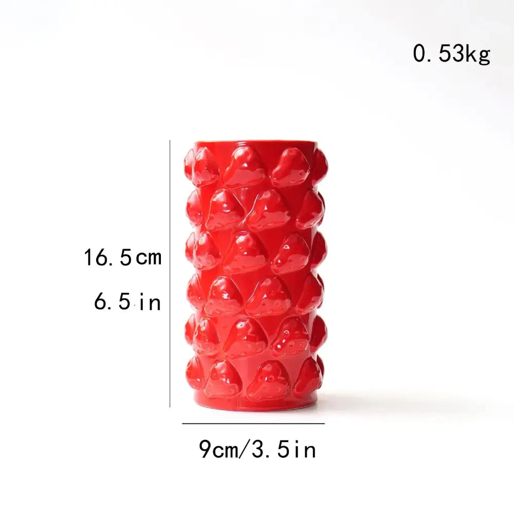 Vibrant red ceramic fruit relief vase with raised glossy strawberry bumps for kitchen decorbites fruit relief decor