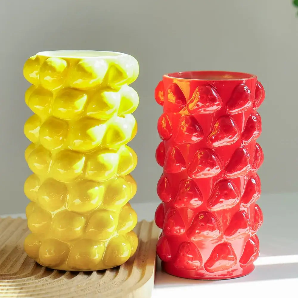 Vibrant yellow and red ceramic fruit relief vase with textured bubble surface for kitchen floral decor by decorbites fruit relief