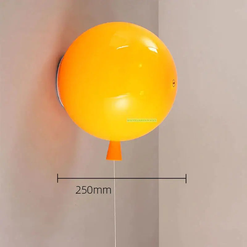 Vibrant yellow balloon lamps wall light with glossy finish and orange nozzle for bedroom decor and ambiance