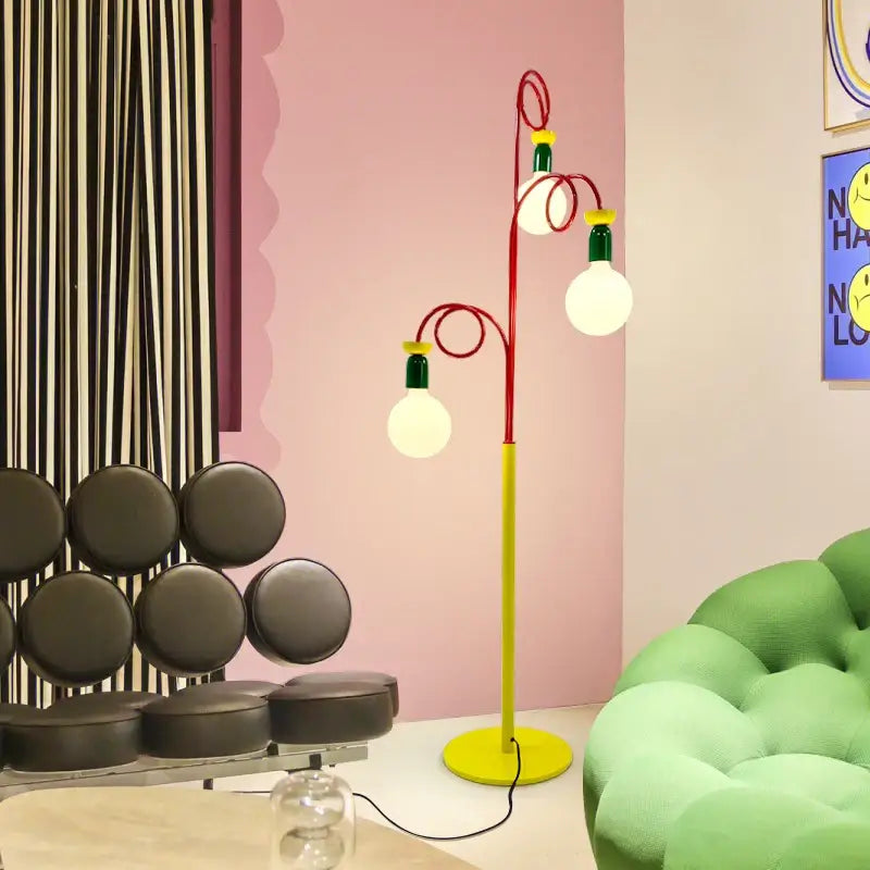 A vibrant red and yellow decorbites art led floor lamp with three glowing bulbs for stylish living room lighting