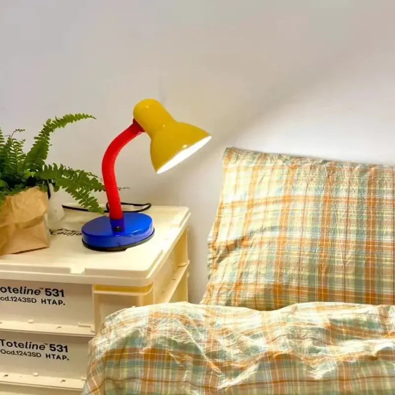 A vibrant yellow and red desk lamp with a flexible neck and blue base decorbites led study desk eye protection light