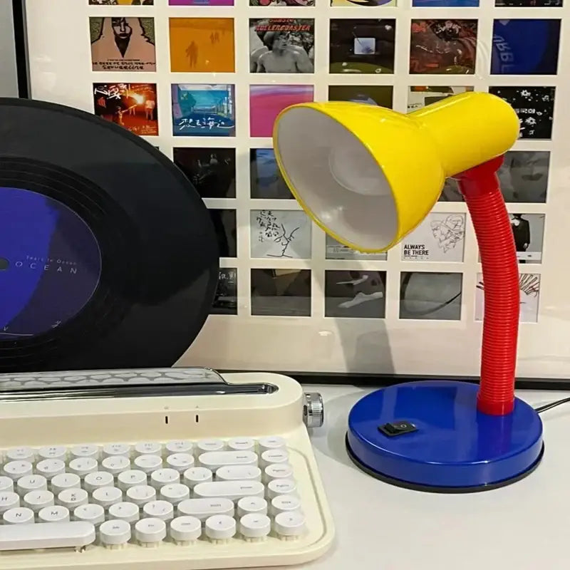 A vibrant yellow and red decorbites led study desk lamp with flexible gooseneck and blue base for eye protection