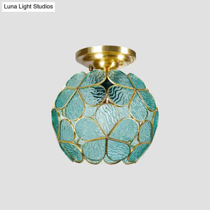 A DecorBites Victorian stained glass flower ceiling fixture with turquoise textured glass and gold metal frame