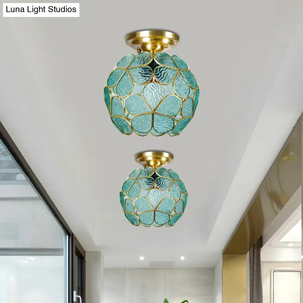 Two teal glass globe ceiling lights with gold metal frames and decorative leaf patterns as stained glass flower ceiling fixtures