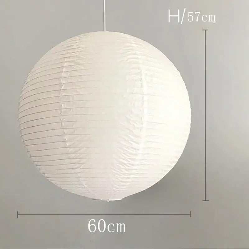 White spherical vintage akari rice paper pendant light with vertical ribbed texture and hanging cord for bedroom or living room