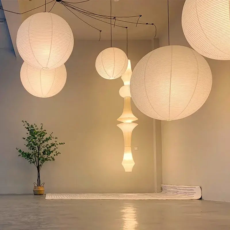 White vintage akari rice paper pendant light with ribbed texture emits soft warm light for bedroom or living room