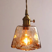 Warm amber alabaster glass pendant lamp with textured glass and brass-finished fixture for living room lighting