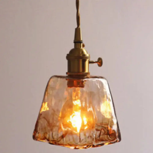 Warm amber alabaster glass pendant lamp with textured glass and brass-finished fixture for living room lighting