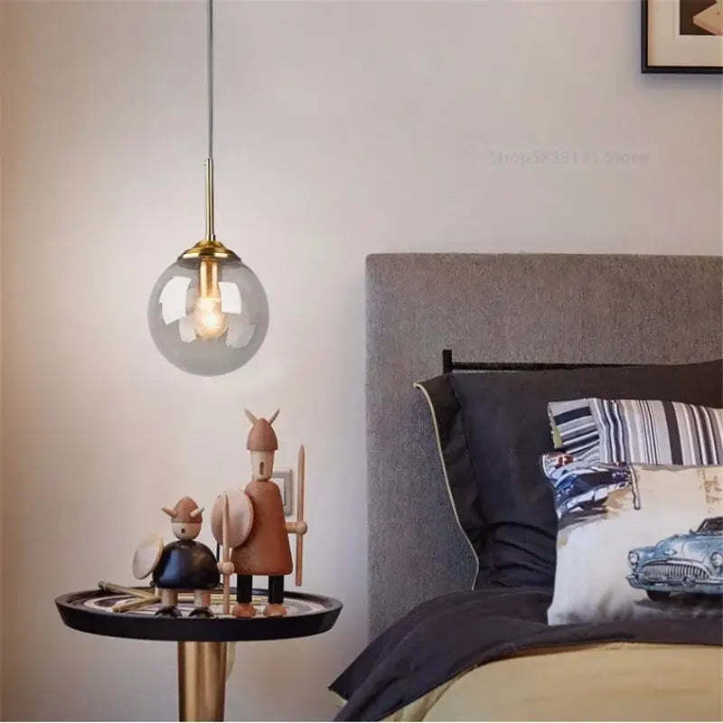 A modern pendant light with a clear glass globe and brass hardware for vintage amber and decorbites gray glass ball decor