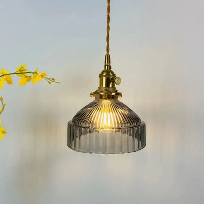 Vintage amber colored glass pendant light with brass fixture and ribbed glass shade for dining room illumination