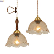 Two vintage style amber cracked glass led pendant lights with brass accents and wooden handles for kitchen decorbites