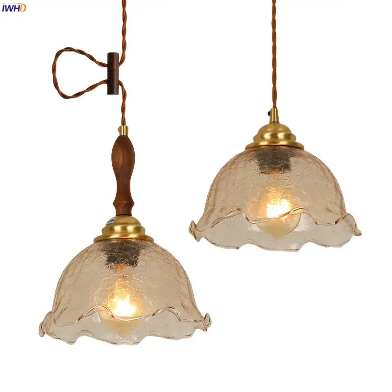 Two vintage style amber cracked glass led pendant lights with brass accents and wooden handles for kitchen decorbites