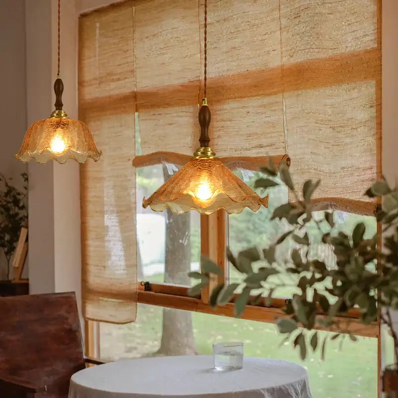 Warm amber glass pendant lights with scalloped edges and brass accents feature decorbites cracked glass led design