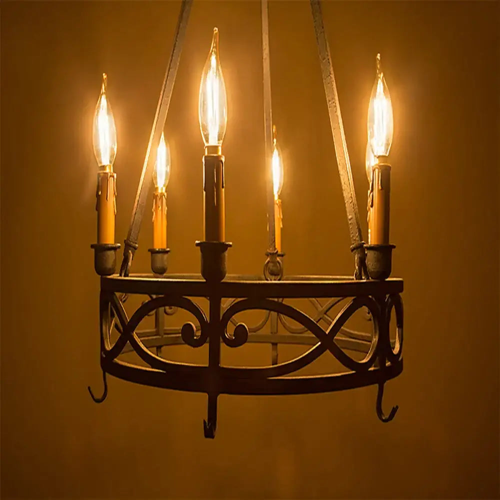 Wrought iron chandelier with five glowing vintage amber dimmable led filament bulbs and ornate scrollwork design for dining room decorbites dimmable led