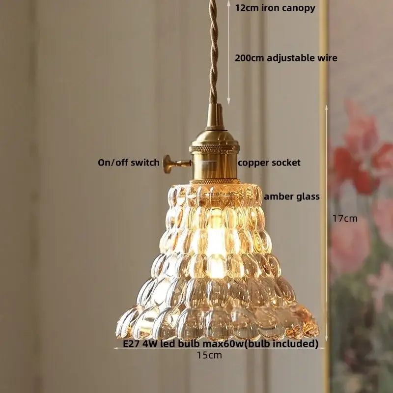 A vintage tiered amber flower glass pendant lamp with brass canopy and copper socket for dining room lighting