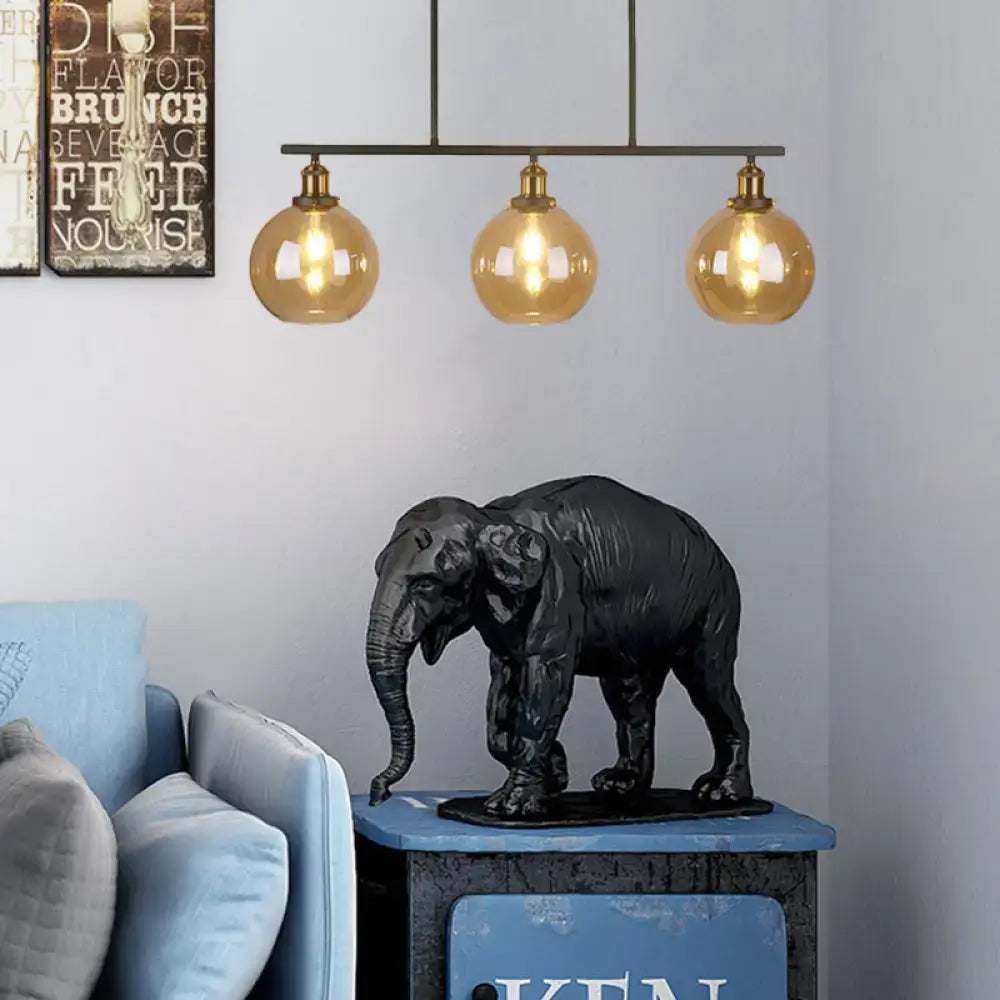 Black matte-finished elephant sculpture with textured surface on dark base complementing amber glass 220v-240v globe cone pendant