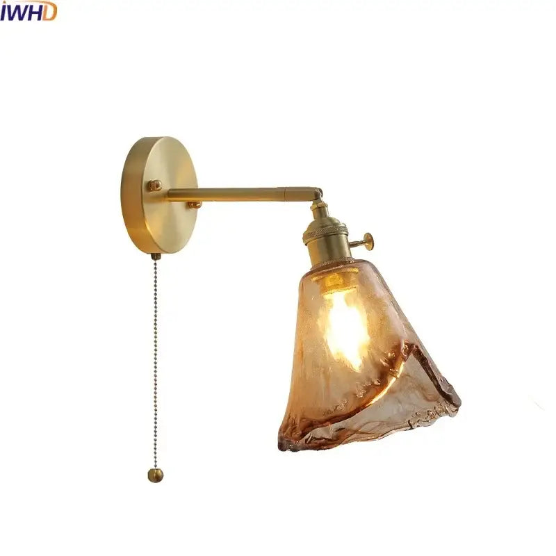 Brass-finished wall lamp with textured amber glass copper led shade and pull chain for bedroom lighting