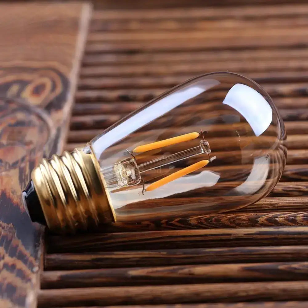Clear glass e27 led edison bulb with brass base and glowing yellow filaments vintage amber glass dimmable e27 led