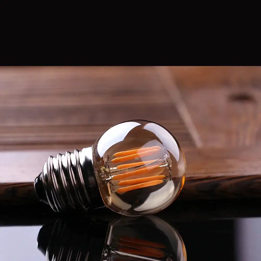 Clear glass globe led bulbs with metallic screw base and visible orange filaments vintage decorbites g40 3w led