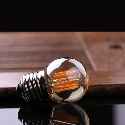 Clear glass globe led bulbs with metallic screw base and visible orange filaments vintage decorbites g40 3w led