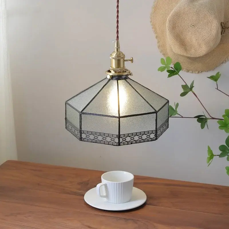 Vintage amber glass led pendant light with brass finish, geometric octagonal gray glass led shade, and black lattice trim