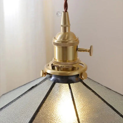 Vintage amber glass led pendant light with brass finish, textured gray glass led panels, and dark metal frame for dining room